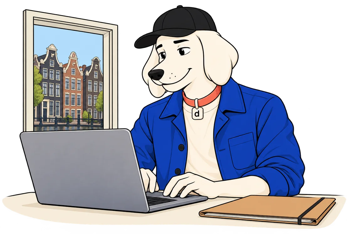 Dugzi working on his own laptop by a window over Amsterdam canal houses.